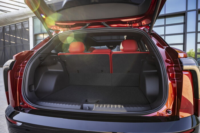 Rear view of 2024 Chevrolet Blazer EV SS in Radiant Red Tintcoat through open trunk. Preproduction m