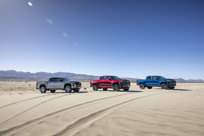 From right to left: pack shot of Colorado Z71, Trail Boss and ZR2 in sandy dessert.