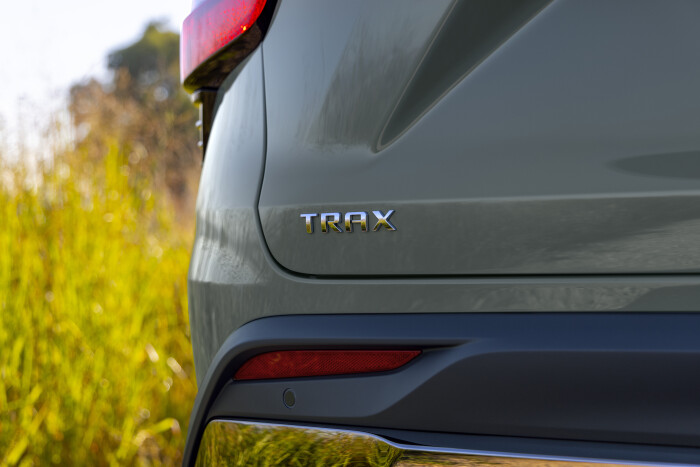 Close-up view of Trax badge on Chevrolet Trax ACTIV in Cacti Green. Pre-production model shown. Actu