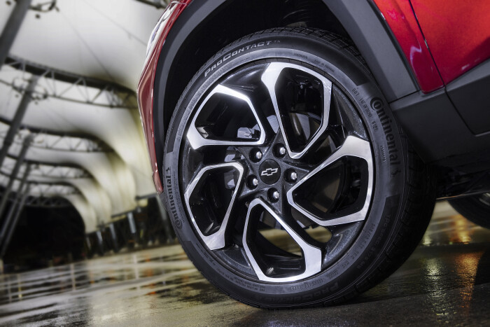 Close-up view of drivers side front wheel on Chevrolet Trax in Crimson Metallic. Pre-production mode