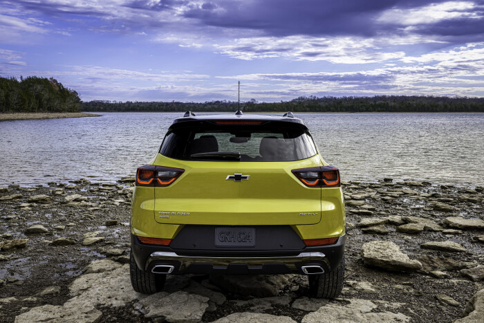 Rear view of 2024 Chevrolet Trailblazer ACTIV parked on rocks in front of a lake. Preproduction model shown. Actual production model may vary. Available in fall 2023.