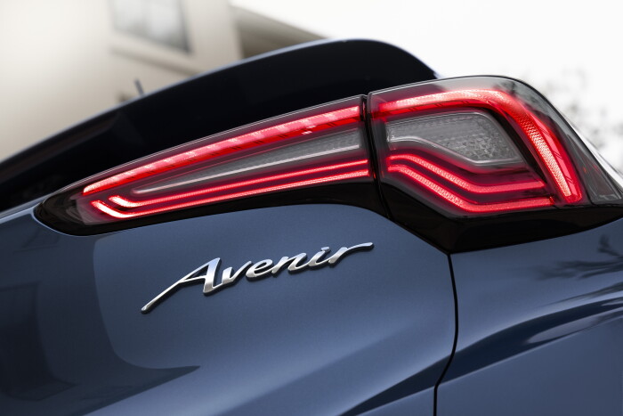 Close up view of the passenger side taillight and Avenir badging on the 2024 Buick Encore GX Avenir in Ocean Blue Metallic. Preproduction model shown. Actual production model may vary. Available in Spring 2023.