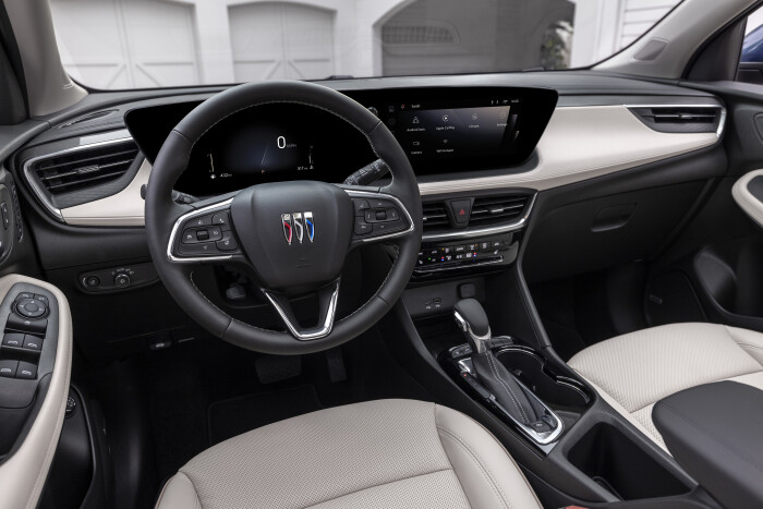 View of the drivers seat in 2024 Buick Encore GX Avenir with Whisper Beige and Jet Black interior. Preproduction model shown. Actual production model may vary. Available in Spring 2023.