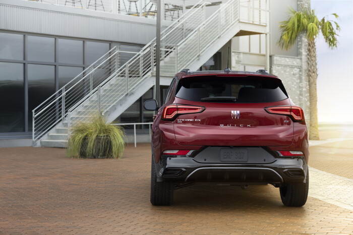 Rear view of the 2024 Buick Encore GX ST in Cinnabar Metallic. Preproduction model shown. Actual production model may vary. Available in Spring 2023.