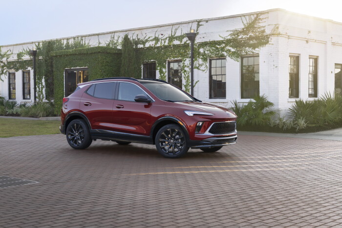 Front 7/8 view of the 2024 Buick Encore GX ST in Cinnabar Metallic. Preproduction model shown. Actual production model may vary. Available in Spring 2023.