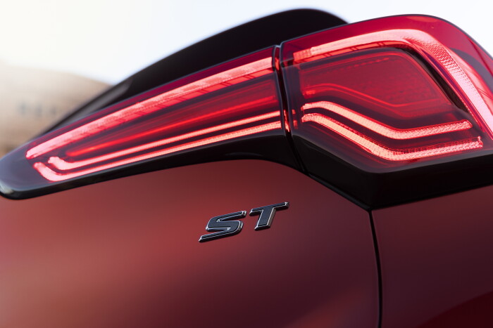 Close up view of the passenger side taillight and ST badging on the 2024 Buick Encore ST Avenir in Cinnabar Metallic. Preproduction model shown. Actual production model may vary. Available in Spring 2023.