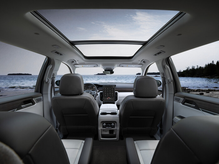 Interior shot showcasing the first and second row of the all-new 2024 GMC Acadia Denali including the 15-inch portrait-oriented screen and 11-inch driver information cluster.