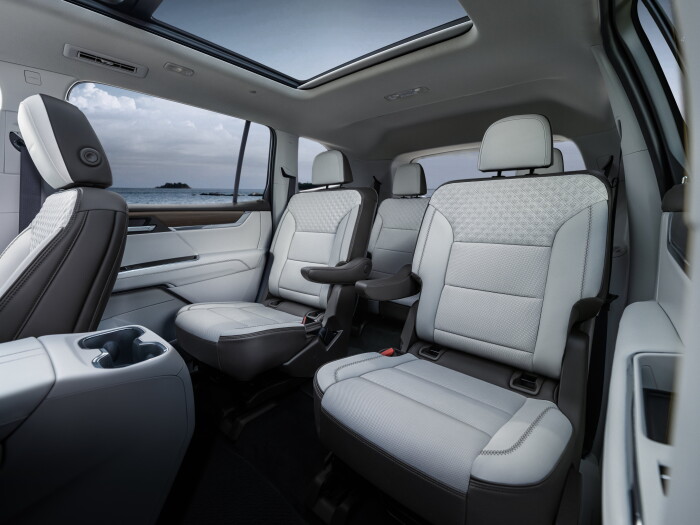 Interior shot of the 2024 GMC Acadia Denali and its new Very Dark Atmosphere perforated leather second row seats.
